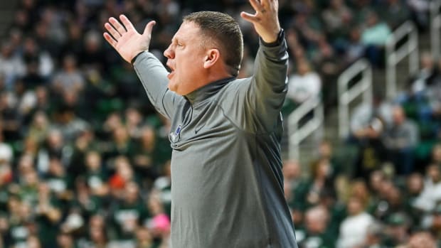 Penn State men's basketball coach Mike Rhoades looks for a foul during the Nittany Lions' Big Ten game at Michigan State.